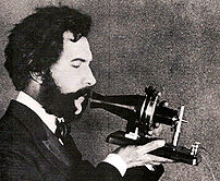 Alexander Graham Bell speaking into a prototyp...